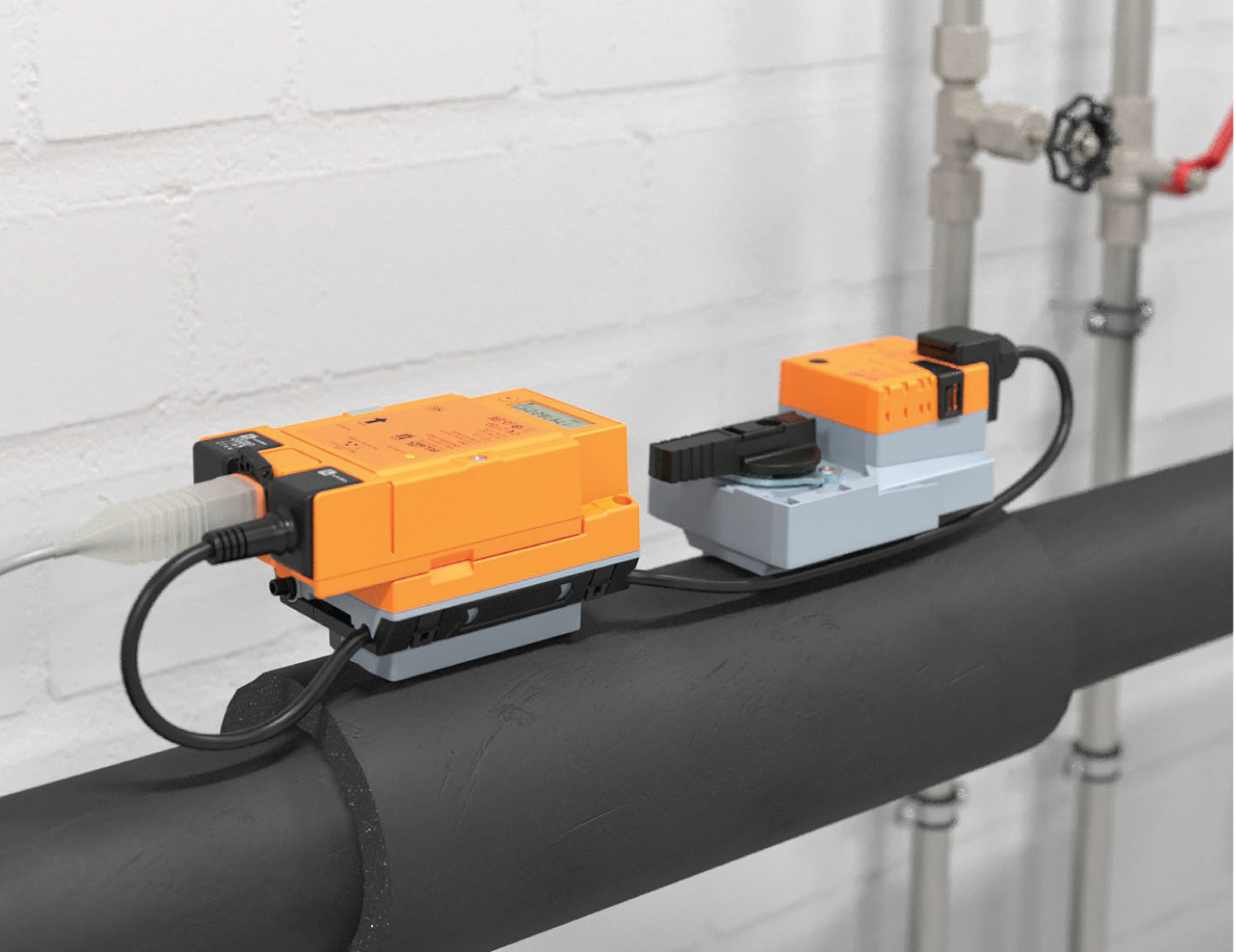 Industrial valves and chilled water pipework in a plant room